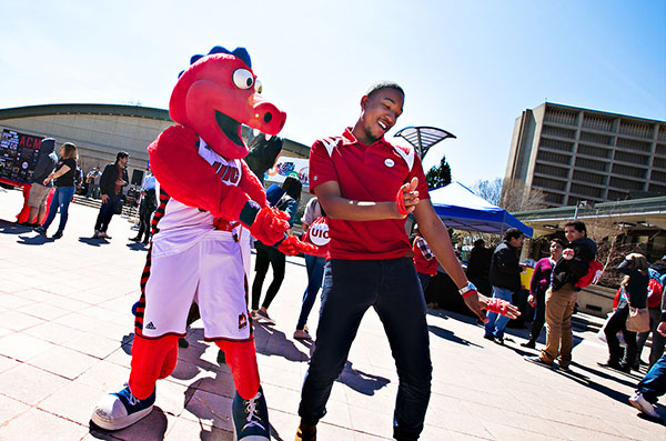 mascot and student dancing in quad